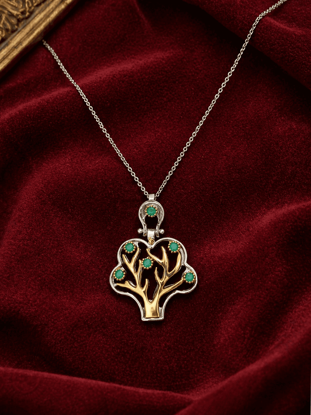 Sapheen jewelry — silver and gold tree pendant with green stones on velvet